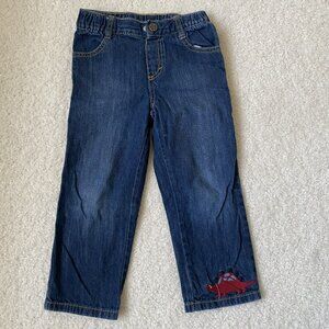 Gymboree denim jeans with a dinosaur embroidery near the hem